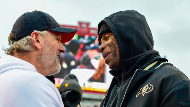 Nov 25, 2023; Salt Lake City, Utah, USA; Colorado Buffaloes head coach Deion 'Coach Prime' Sanders congratulates Utah Utes head coach Kyle Whittingham after the Utah Utes victory over the Colorado Buffaloes at Rice-Eccles Stadium. Mandatory Credit: Christopher Creveling-USA TODAY Sports